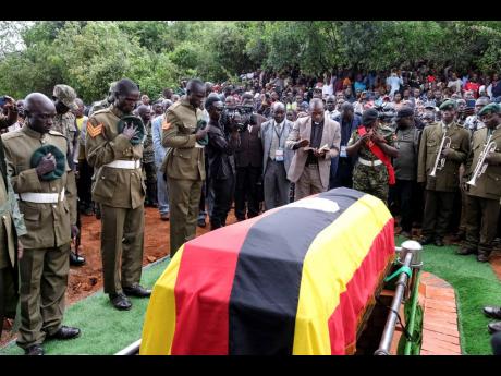 
Members of the Uganda People’s Defence Force pay their respects at the funeral of Ugandan Olympic athlete Rebecca Cheptegei as her casket is lowered into the grave in Kapkoros, Bukwo District, Uganda, yesterday.