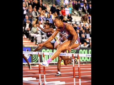 
Jamaica Ackera Nugent (left) goes in chase of Cuba’s Jasmine Camacho-Quinn during the Diamond League in Brussels, Belgium, yesterday.