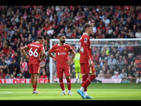 
Liverpool’s players react after Nottingham Forest’s Callum Hudson-Odoi scores during their English Premier League football match at Anfield in Liverpool, England, yesterday.