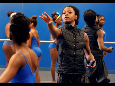 Michaela DePrince, center, instructs intermediate ballet students at BE Dance Studios in Miami Gardens, Fla. on July 14, 2015. 