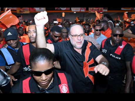 Golding arrives at the PNP’s 86th annual conference.