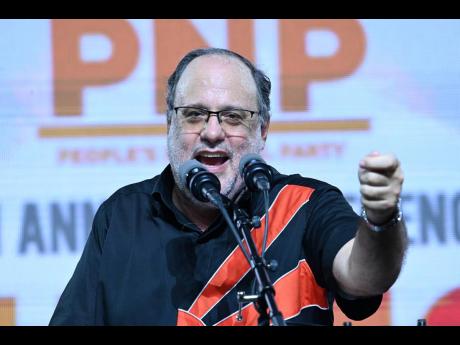 Mark Golding, opposition leader and president of the People’s National Party, addresses the party’s 86th annual conference at the National Arena in Kingston yesterday.