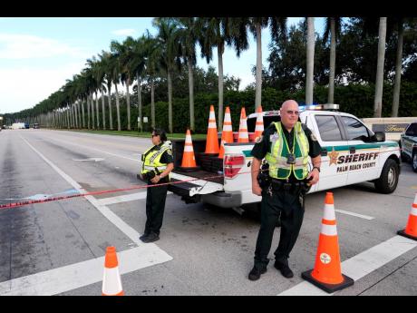 Officers with the Palm Beach County Sheriff’s office work outside of Trump International Golf Club, after the apparent assassination attempt of Republican presidential nominee and former President Donald Trump, on Monday in West Palm Beach, Florida. 