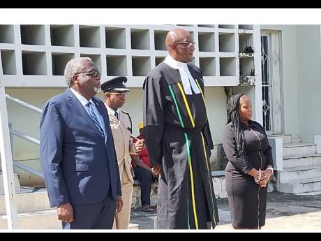 Custos of St James Bishop Conrad Pitkin (left), High Court Judge Justice Bertram Morrison (second left) and Parish Judge Natiesha Fairclough-Hylton take part in yesterday’s inspection of the guard of honour during the opening of the St James Circuit Cour