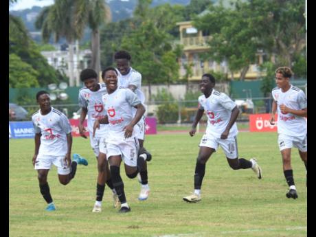 Mona High School players celebrate after scoring against Waterford during the opening match of ISSA/WATA Manning Cup football competition at Montego Bay Sports Complex on Saturday opening day, September 7. Mona won 7-0.