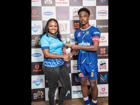 Melissa-Kim Johnson (left), consumer marketing manager, Wisynco Group, presents the Man of the Match trophy to Nashan Bolt of Clarendon College following his outstanding performance in the opening ISSA 2024 daCosta Cup competition. The match, held at the C