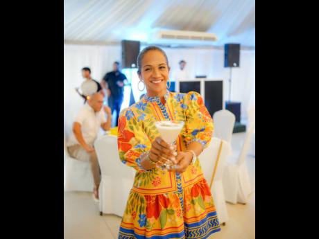 Alicia Bogues, head of regional development, CB Group, shows off her ‘boozy’ cocktail at SIPS: The High Tea Boozy Brunch, held on Sunday in celebration of 10 years of the Jamaica Food and Drink Festival.