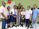 Members of the winning Oracabessa Primary School ACE Quiz Bowl team with Gregory Davis (left), principal; Winston Moncrieffe (centre), quizmaster; Althia Duckie-Foster (second right), general manager, Galina Breeze Hotel; and team coach, Cleon Willis (right).
