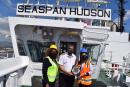 Jamaica Freight & Shipping Company account executives Michelle Allison-Morris (left) and Kimberly Kelly present a commemorative plaque to Captain Glen Campbell of the ‘Seaspan Hudson’.