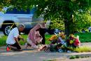People pay their respects outside the scene of a shooting at a supermarket in Buffalo, New York.
