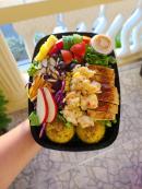 A tasty dish containing grilled chicken and grilled lobster salad, inclusive of fruits and vegetables, with sweet mashed potato on the side. 