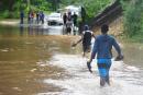 Two men wade through a flooded section of Rasta Corner in Free Town, Clarendon after the passage of Tropical Strom Ian on Monday, September 26. 