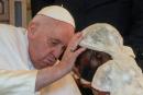 Pope Francis caresses a victim of violence in eastern Congo, at the Apostolic Nunciature in Kinshasa, Democratic Republic of Congo, on Wednesday.