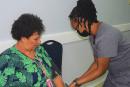 Vice-President of the Shipping Association of Jamaica, Corah Ann Robertson Sylvester (left), gets her blood pressure checked by Newport Medical Group’s Nurse Burke during the body’s complimentary screening on World Hypertension Day.