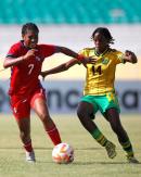 Panama Under-20's Sherline King and Jamaica's Destiny Powell challenge for a ball during their Concacaf Under-20 Women's Championship football game at the Estadio Felix Sanchez in the Dominican Republic this afternoon.  