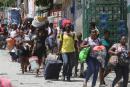 Residents flee their homes to escape clashes between armed gangs in the Carrefour-Feuilles district of Port-au-Prince, Haiti, in August.