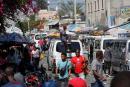 Pedestrians and commuters fill a street in Port-au-Prince, Haiti.