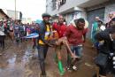 Residents rescue a woman who was caught during heavy rain in the Mathare slum of Nairobi, Kenya, on Wednesday.