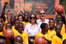Prince Harry and Meghan, centre, pose for a photograph with children during the Giant of Africa Foundation at the Dream Big Basketball clinic in Lagos Nigeria, Sunday, May 12. Prince Harry and his wife Meghan are in Nigeria to champion the Invictus Games, 